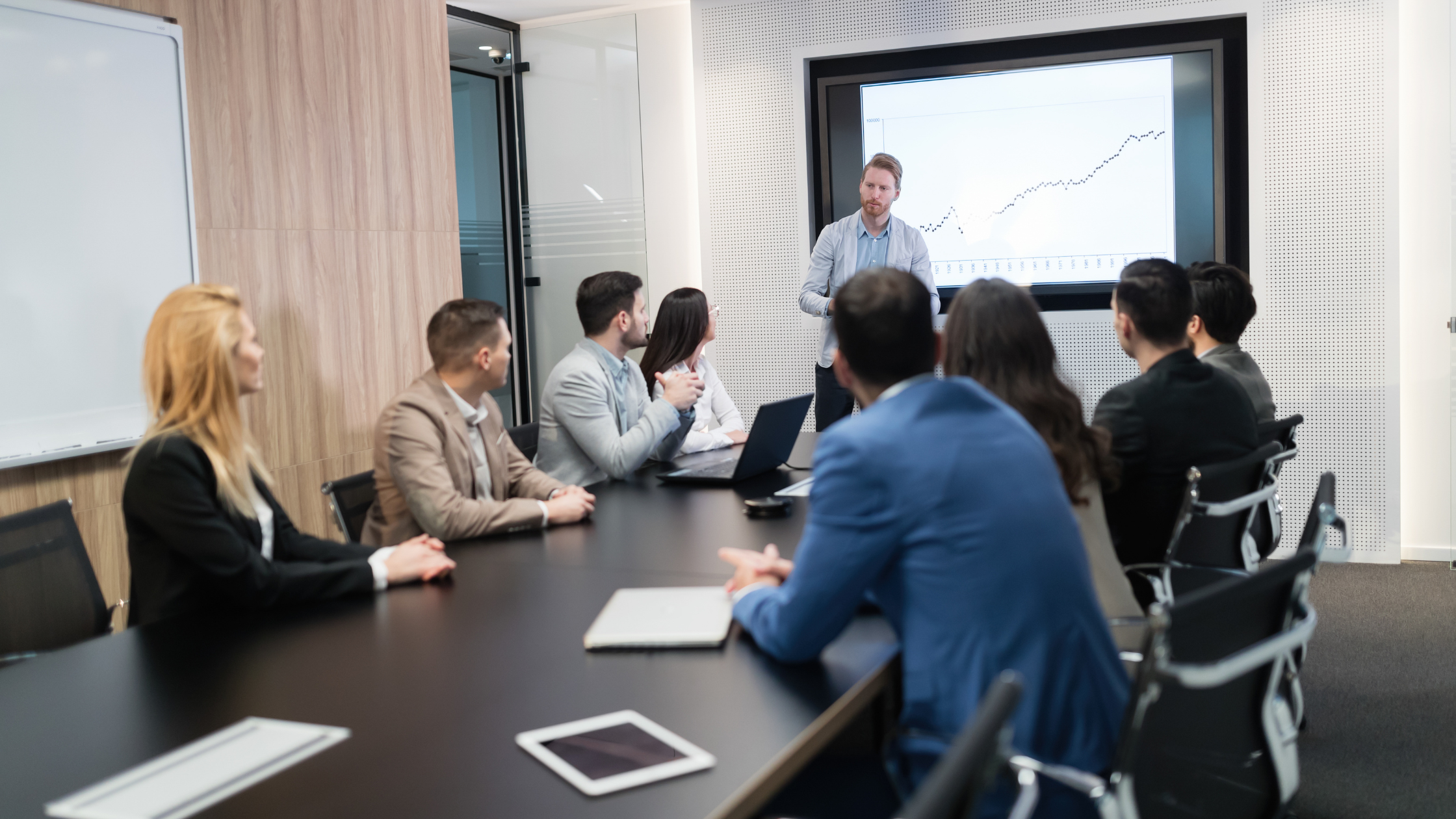 A team at a conference table discuss cyber security